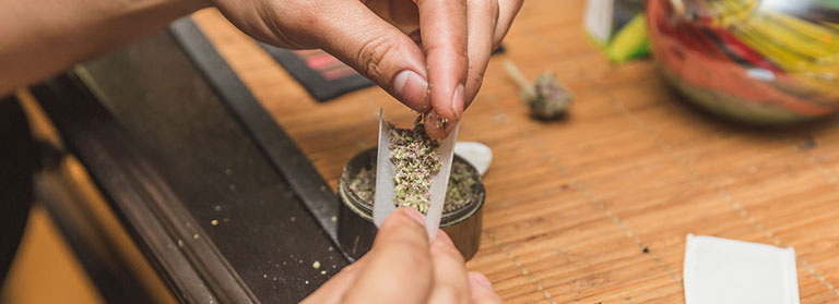 man-rolling-marijuana-joint-with-bare-hands